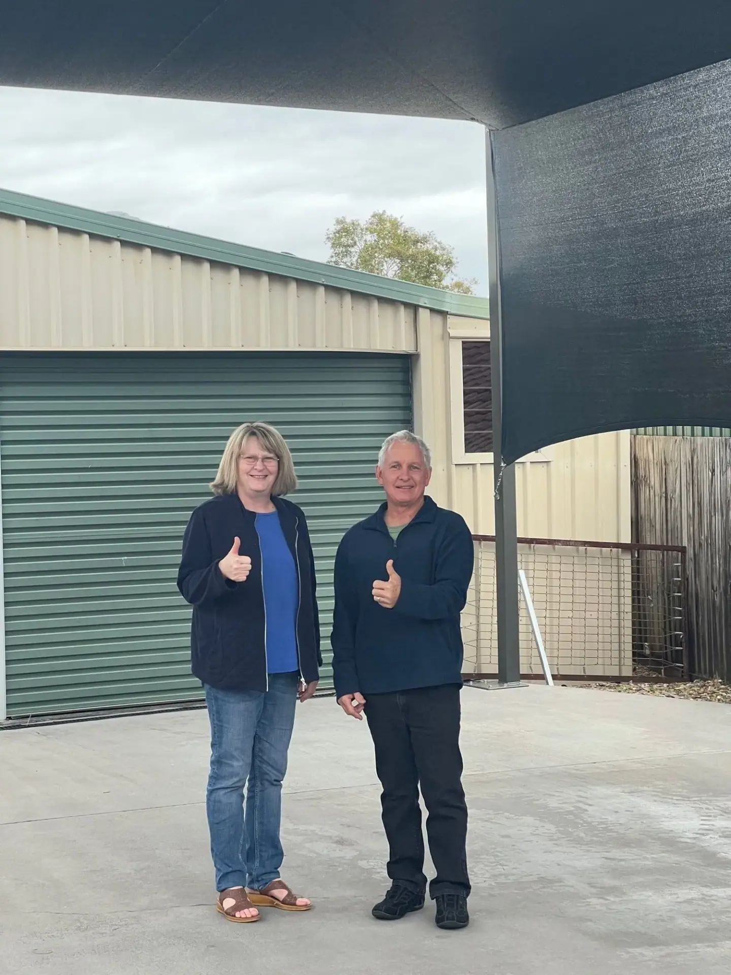 Custom free standing caravan shade sail installed on Zeus Drive, Burpengary, featuring 3.45 metre clearance, six Monument powder-coated steel posts and Rainbow