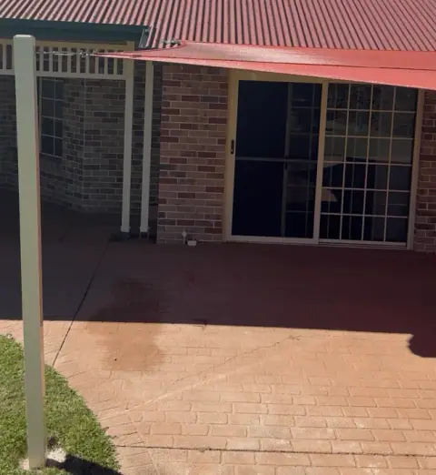 Custom carport shade sail in Burpengary with four steel posts and three roof rafter brackets.