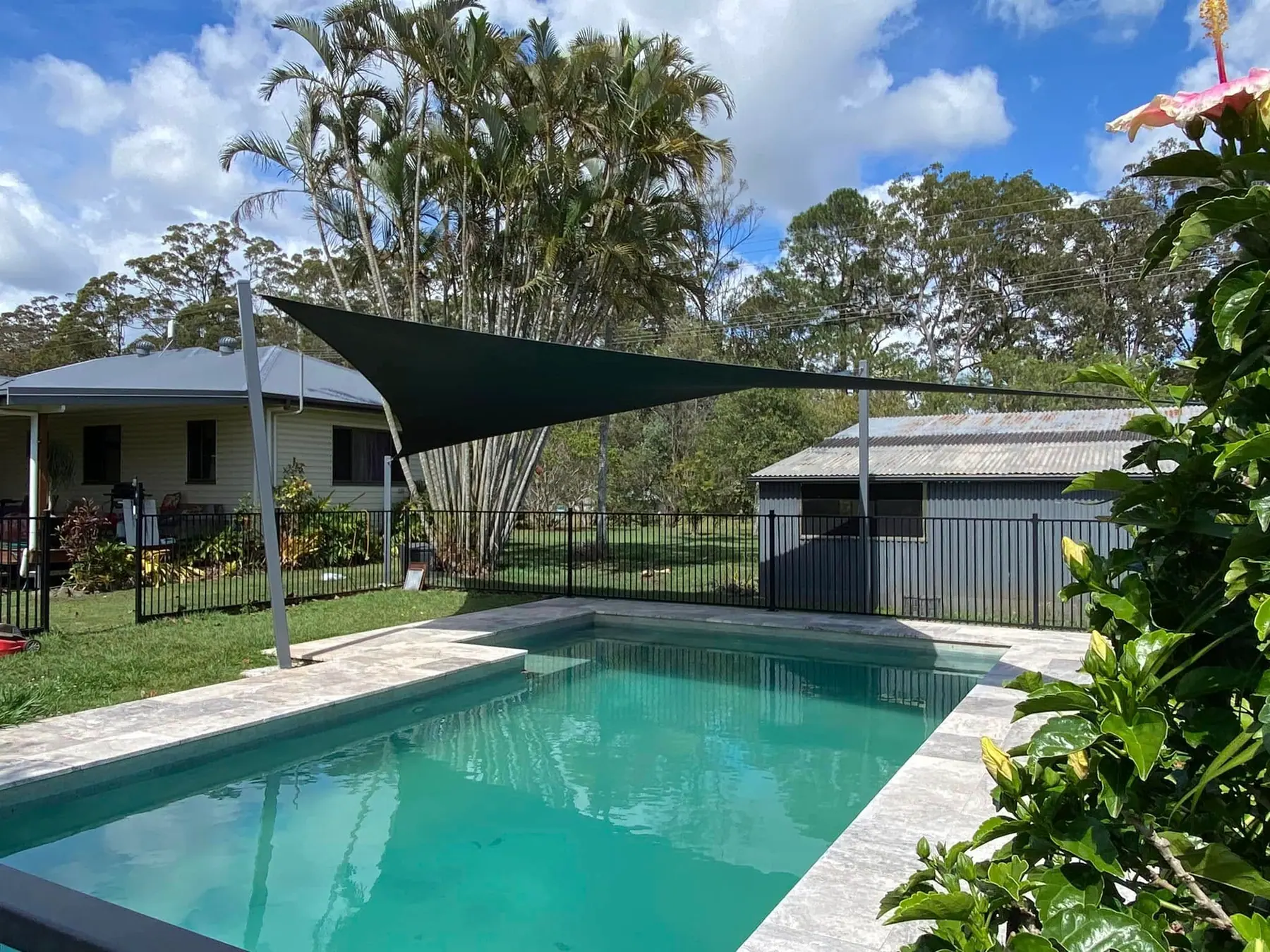 Complete view of the pool and shade sail installation.
